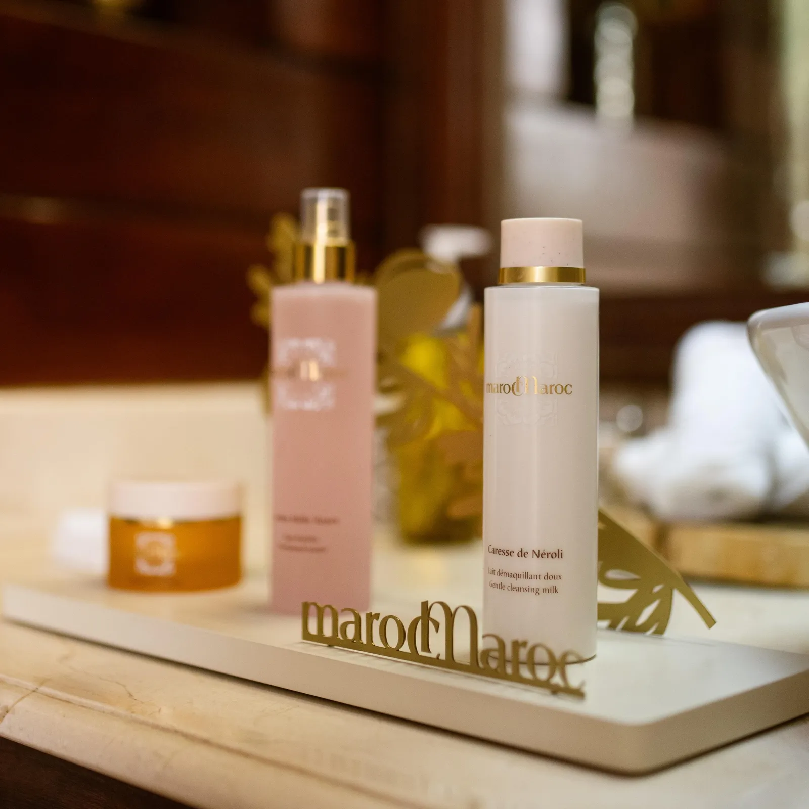 Two bottles of MarocMaroc brand cosmetics placed on a marble surface
